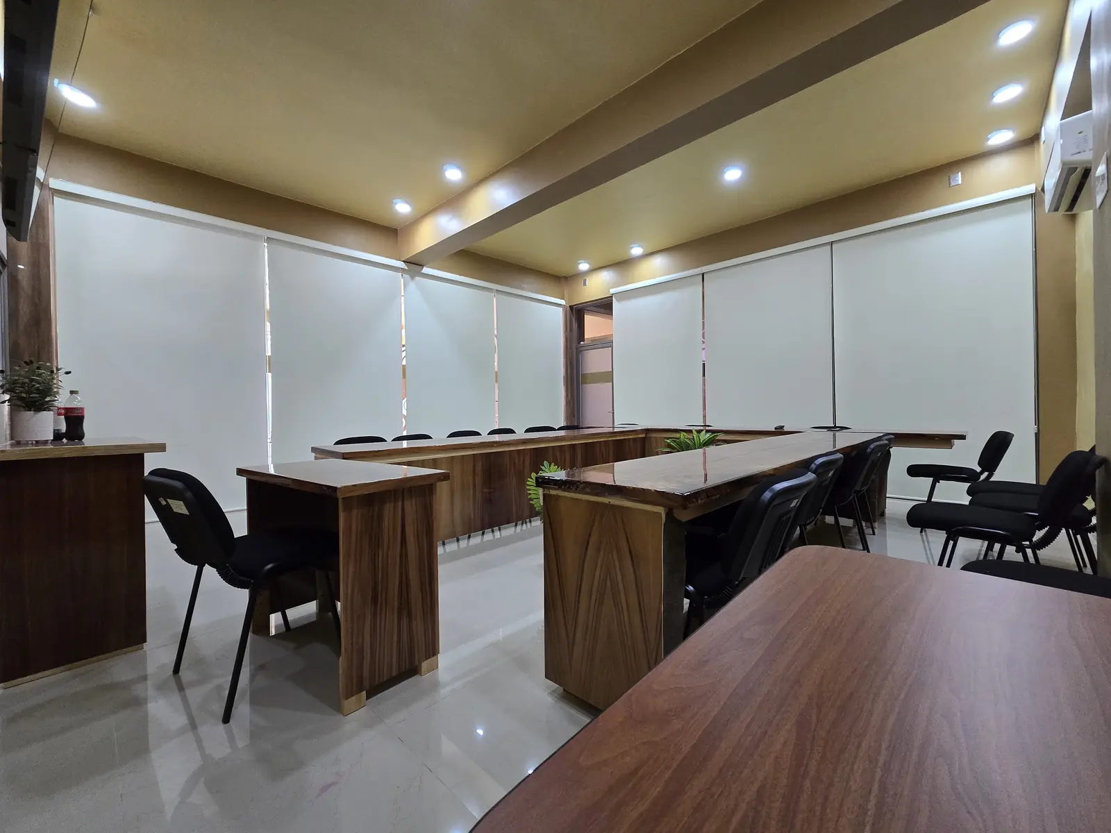 Sala de juntas de oficina con persianas enrollables blancas